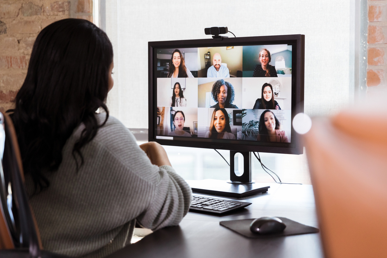 Businesswoman meets with colleagues during virtual staff meeting